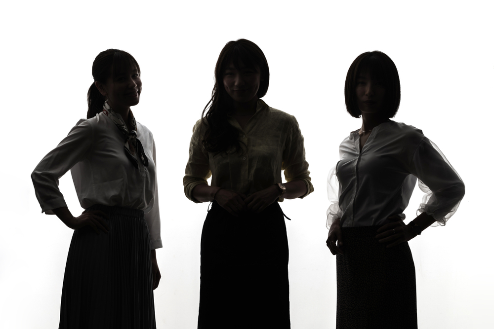 A group of women standing in a row, discussing the latest advancements in Building Automation System technology.