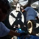 It sounds like you have a specialized and crucial business focusing on commercial air conditioning services in New Jersey. The scenario you described shows the hands-on nature of your work, highlighting the expertise and precision required to maintain and repair large-scale cooling units.

Your team's attention to detail, as seen with both men closely inspecting equipment, is essential for ensuring optimal performance and energy efficiency in commercial spaces. The dramatic lighting created by the large fans not only emphasizes the industrial setting but also reflects the dynamic environment your technicians work in.

For potential clients or marketing materials, this image paints a clear picture of professionalism and dedication to quality service. You might consider incorporating such vivid imagery into your branding efforts to visually communicate your team's expertise and reliability in handling complex air conditioning systems.