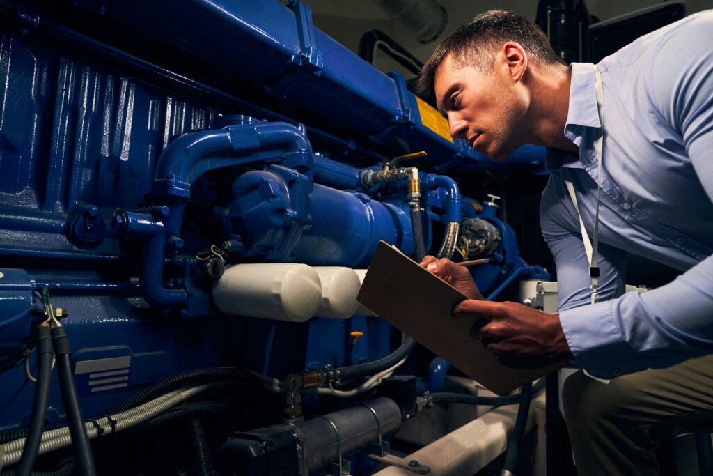 A man examines a generator which helps commercial buildings protect against power outages