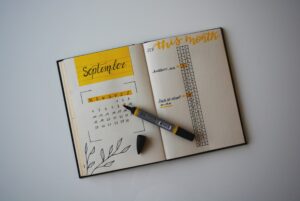 Open planner showing a September calendar on the left page and a this month list on the right, with a marker and eraser ready for those unusual moments or Commercial HVAC appointments.